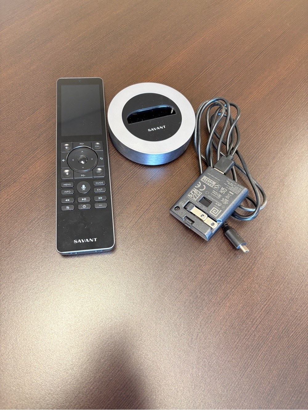 Savant remote control with charging dock and power cord.